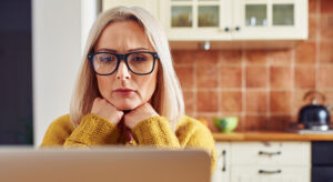 Woman looking at house insurance and what her property would cost to rebuild