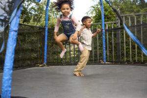 children playing on the trampoline, striking the balance