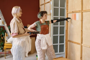 Two ladies decorating a house, homebuyers in new home