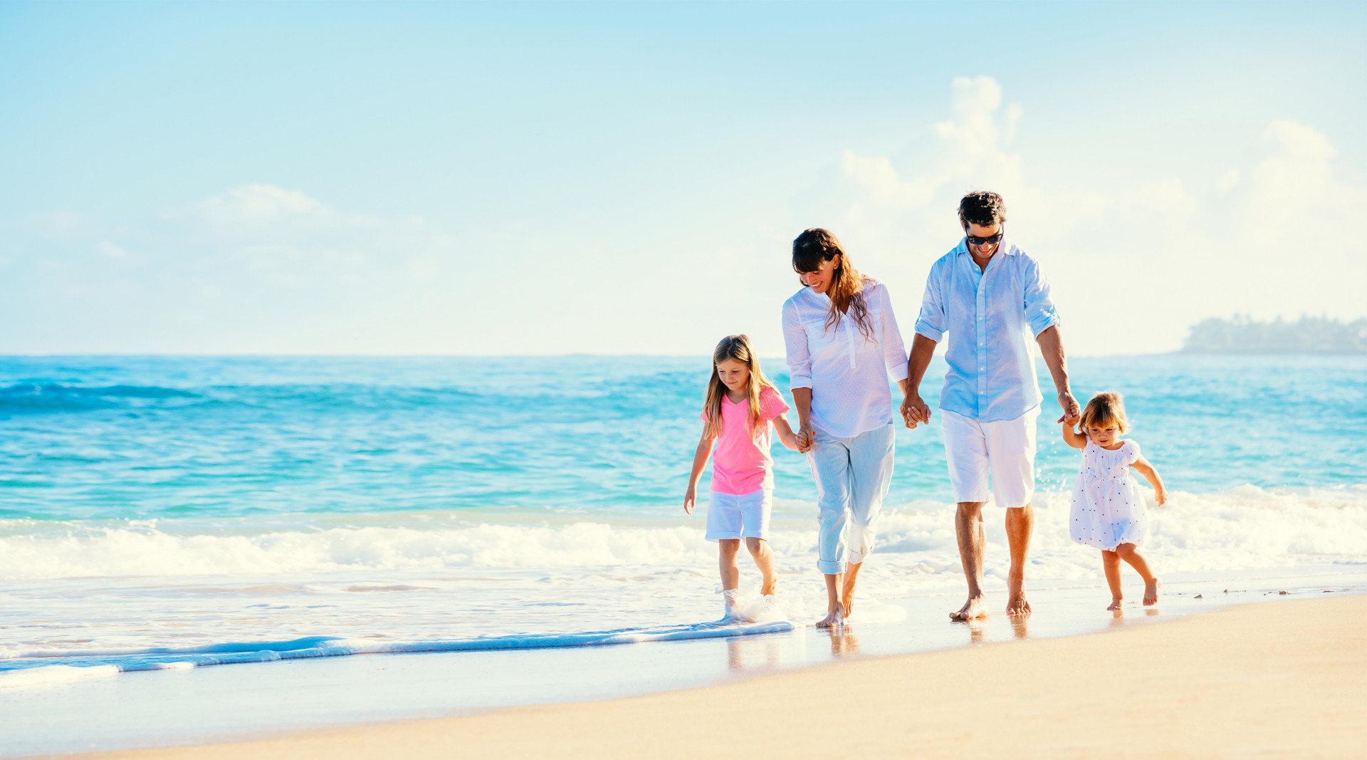 Young family walking on the beach